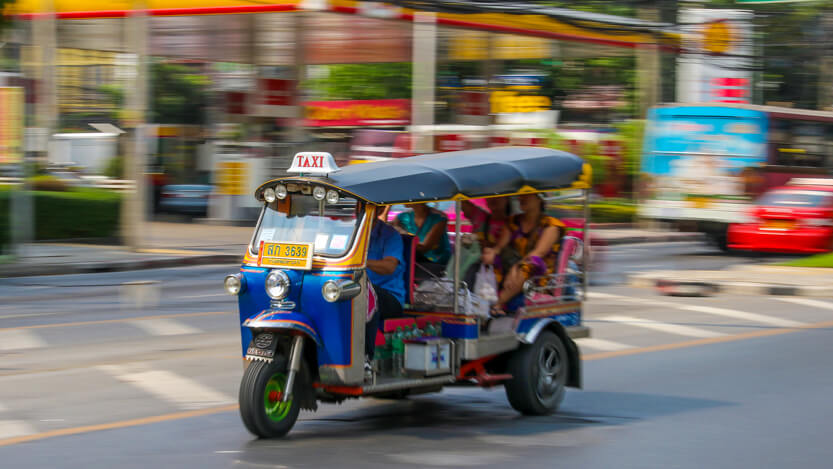 Tourists riding in tuk tuk